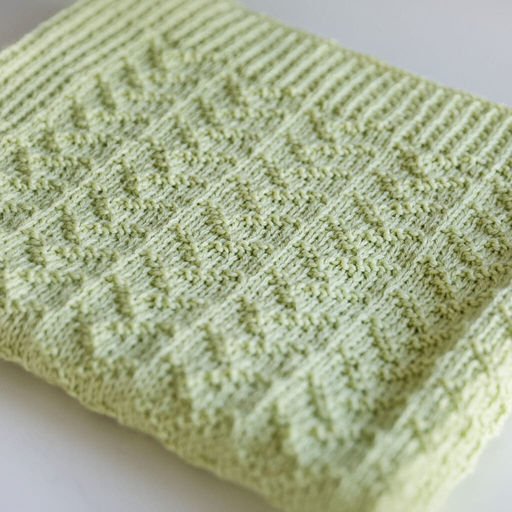 Knit Baby Blanket Folded - knit purl baby blanket knitting pattern